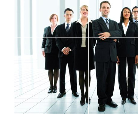 A business team in suits standing together in a bright office.